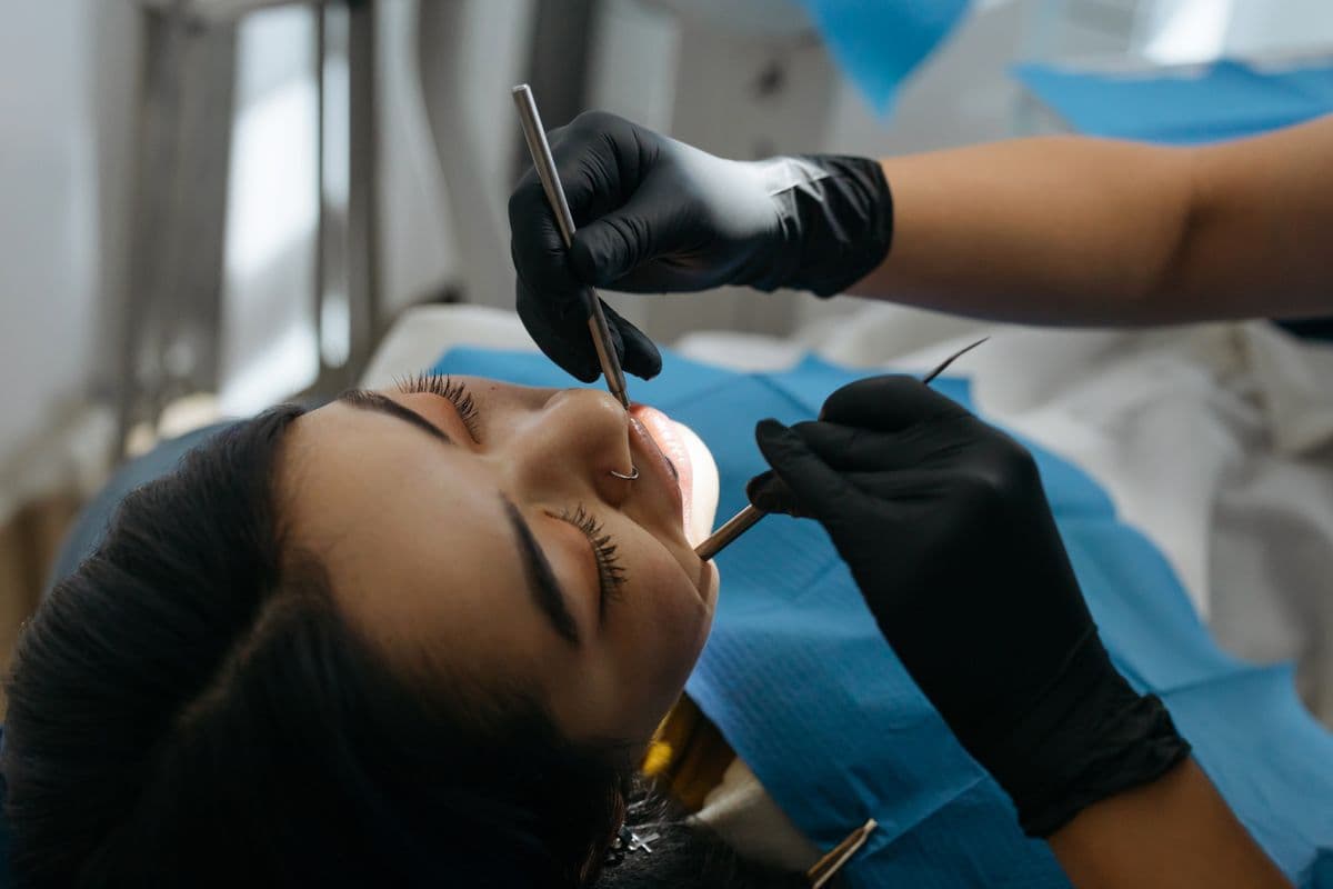 Close-up of a dental professional performing a digital intraoral examination